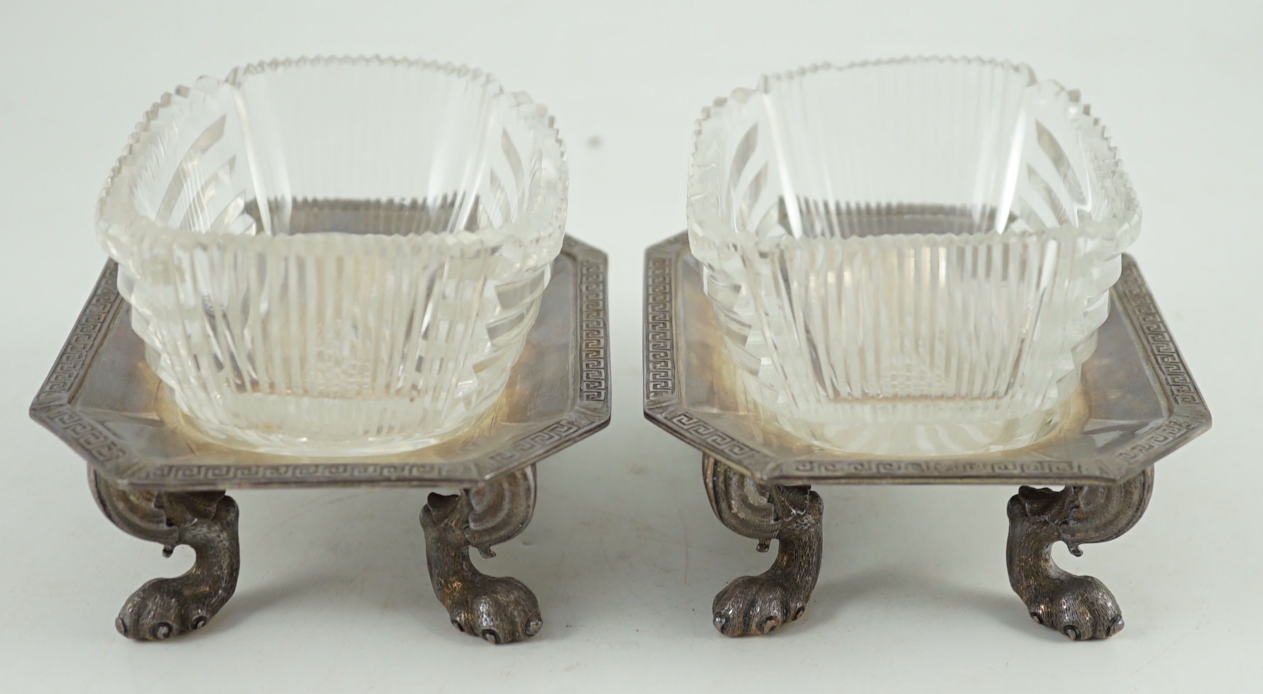 A pair of George V silver salt cellars, with cut glass liners